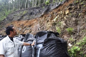 Eiichi Kukiyama is watching the scene of a landslide at the area of Kimura on the island. (Kuchinoerabu-jima island, Kagoshima prefecture)