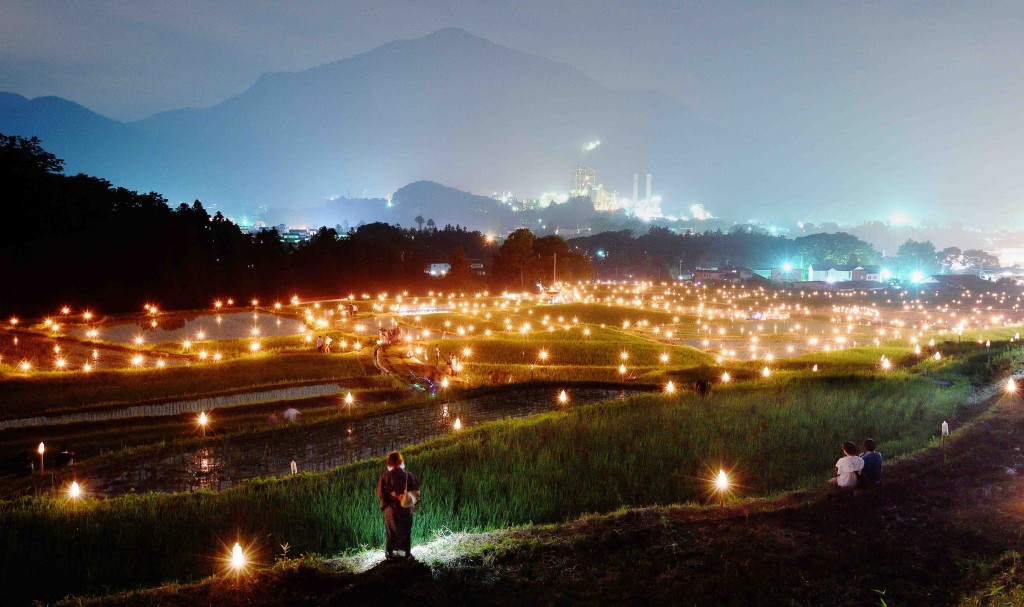 Shining lights in stepped rice paddy with Mt. Buko and city lights in the background (in Yokoze-machi, Saitama Prefecture)
