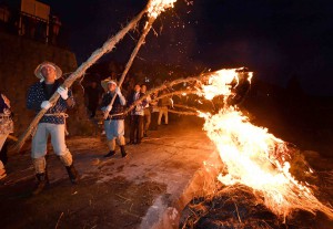 Young locals with flambeaux walking toward boats