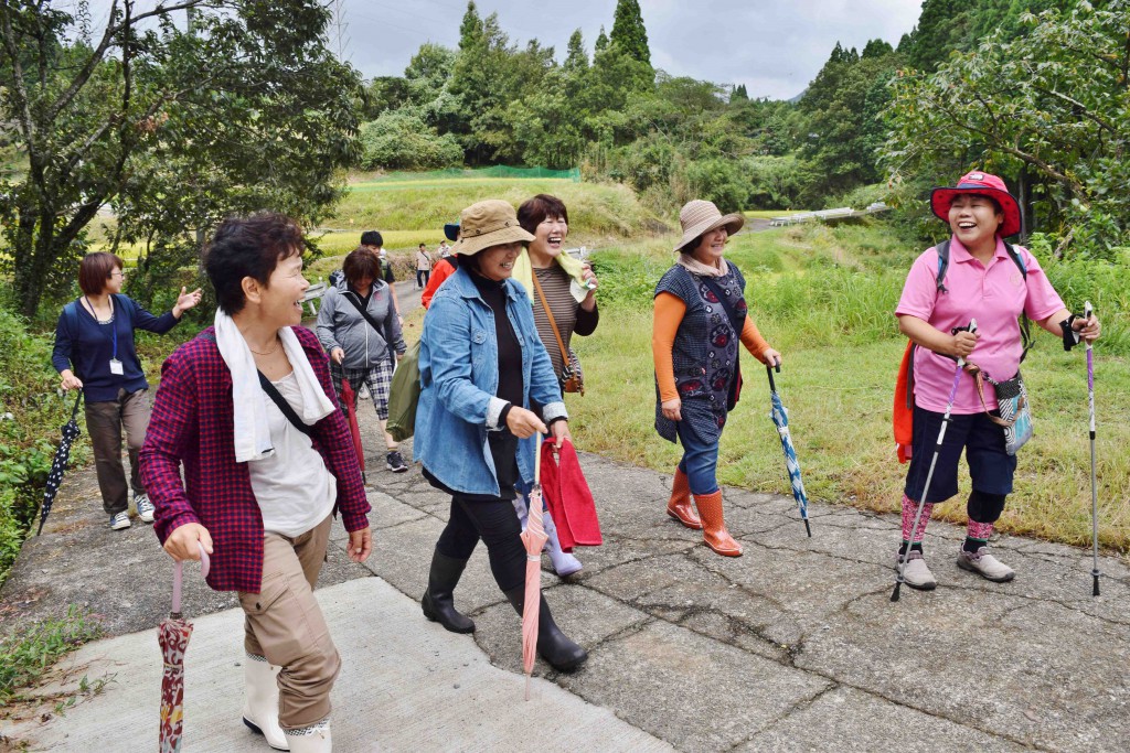 Visitors to Misato, Kumamoto Prefecture, walk on a footpath that was reopened after the April earthquake. 