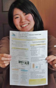 Koshio showing reduce copy of her presentation material at ISAE conferrence