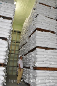 Bags of imported rice are stacked high up to the ceiling in a warehouse in the city of Chiba.