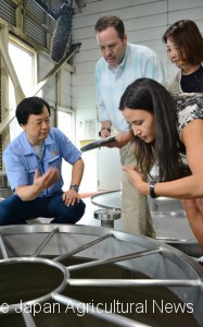 Buyers of alcoholic beverages from the United States talk with a distiller in Hitoyoshi, Kumamoto Prefecture, during a tour organized to increase recognition of shochu in overseas markets.