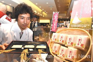 Researcher Hiroki Nakamura, with Princess of Fragrance, new fragrant Japanese rice he developed at Tottori Agricultural Research Center.