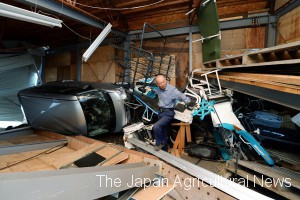 A farmer of Atsuma, Hokkaido, on Sept. 7 looks at his warehouse destroyed by a powerful earthquake which hit the region the day before.