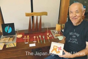 Yoshitsugu Okada shows a wooden puzzle and other craftwork he produced using old tea trees in Koka, Shiga Prefecture.