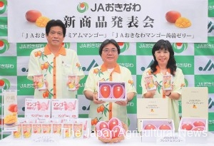 JA Okinawa officials show their new mango products in Naha, Okinawa Prefecture.