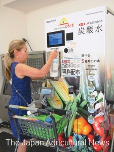 A shopper refilling carbonated water at the vending machine installed in a local farmers’ market (In Ibaraki Town, Ibaraki Prefecture)