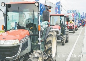 Five tractors lead a rally of farmers and consumers in the city of Yamagata.